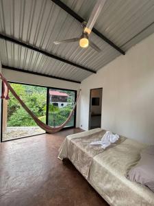 a bedroom with a bed and a ceiling fan at Casa La Kin in Cacahuatán