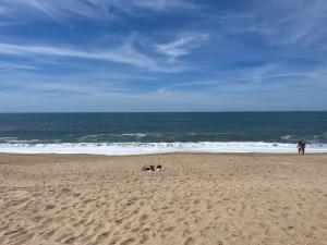 a group of people sitting on the beach at GuestReady - Bright & Inviting Stay in Vila Nova de Gaia