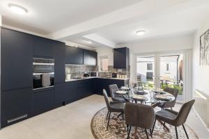 a kitchen and dining room with a table and chairs at Modern Studio Central Location Private Bathroom and shared Kitchen 2 in Edgware