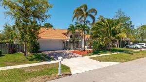 a house with palm trees and a driveway at Modern 4BR in Central Wellington- Walk to Shops in Wellington