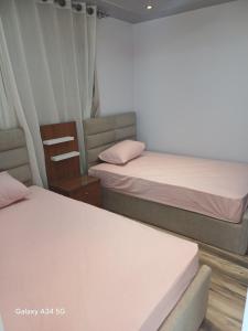 a room with two beds and a chair at الفيروز شقه فندقيه الفيوم دله in Fayoum Center