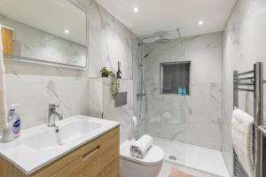 a white bathroom with a sink and a shower at Bespoke Studio 23 Min - C London Private Bathrroom Shared Kitchen 3 in Edgware