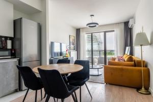 a kitchen and living room with a table and chairs at The View Belgrade Waterfront in Belgrade