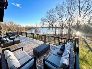 a patio with couches and a view of the water at Tucked Away on the Ridge - Quiet Fall Lake Retreat in Cadiz