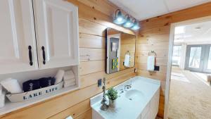 a bathroom with a sink and a mirror at Tucked Away on the Ridge - Quiet Fall Lake Retreat in Cadiz +55 photos