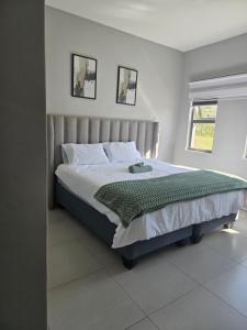 a bedroom with a large bed in a room at WeThusiCBD in Mbabane