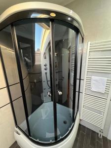a shower with a glass door in a bathroom at Apartments VRAZOVA in Sarajevo