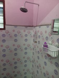 a bathroom with a shower with a sink at Ekaira homestay in Tambun +9 photos