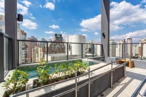 a balcony with a swimming pool on top of a building at Studios Prime Pivô Match - Jardins in Sao Paulo