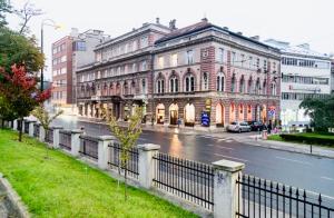 a building on a city street with a fence at Apartments VRAZOVA in Sarajevo