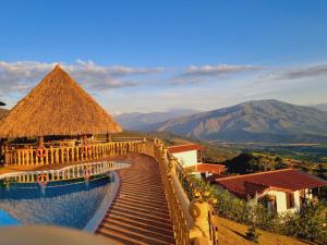 a resort with a swimming pool and mountains in the background at cabañas campestres buena vista in Paicol +39 photos