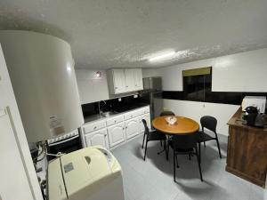 a kitchen with a wooden table and chairs and a table and a table at ValverdeApart in Madalena