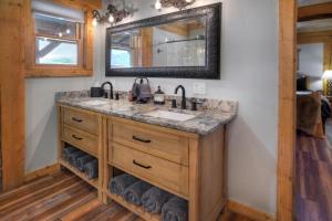 a bathroom with a sink and a mirror at Homestake Cabin in Creede +28 photos