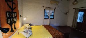 a bedroom with a bed and a window at La morada del monte in Yerba Buena