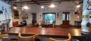 a living room with a large wooden table and chairs at La morada del monte in Yerba Buena