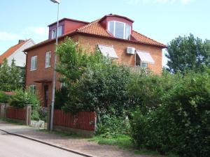 a red brick house with a red fence at Honeymoon Seaview Apartment in Helsingborg