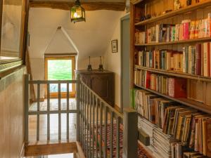 a hallway with bookshelves filled with books at Charmante maison de paludier à Guérande, proche mer, jardin, tyrolienne, WIFI, Canal+, équipements bébé - FR-1-306-1102 in Guérande