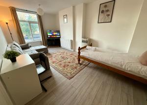 a living room with a bed and a couch at Enormous Family Flat (7 guests) in London