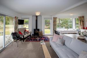 a living room with a couch and a fireplace at House Horse & Hound on Argelins in Hanmer Springs
