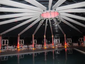 a pool with tables and chairs in a building at Kaya Palas Hotel in Kırklareli +56 photos