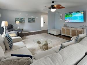 a living room with a couch and a tv at Dolphin Paradise in Aransas Pass