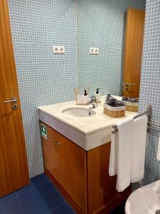 a bathroom with a sink and a mirror at Cosy Home Azores in Lagoa +28 photos