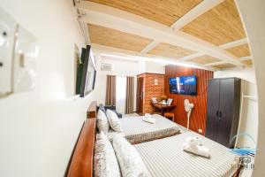 a living room with a couch and a bed at CJ by the Bay in Olongapo