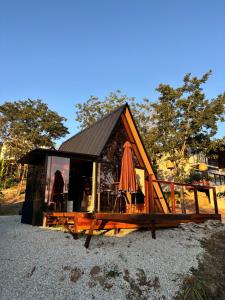 a small cabin with an umbrella and a table at Chalés Piribless-Oásis in Pirenópolis