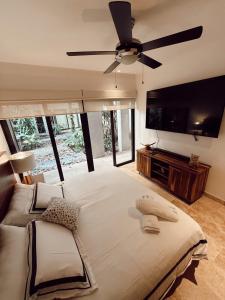 a large bedroom with a large bed and a flat screen tv at Ipana Luxury by Felix in Playa del Carmen