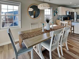 a dining room and kitchen with a table and chairs at Blue Me A Wave in North Topsail Beach +42 photos