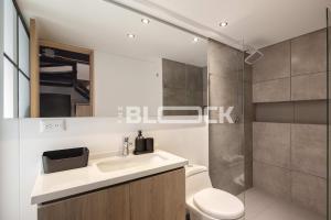 a bathroom with a sink and a toilet and a shower at Udara Polo - The Block in Bogotá