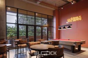 a restaurant with tables and a pool table at Udara Polo - The Block in Bogotá