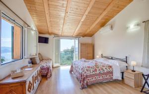a bedroom with a bed and a large window at La Casetta Tra Cielo E Mare in San Lorenzo della Costa
