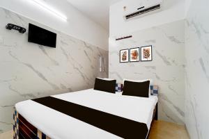 Postel nebo postele na pokoji v ubytování Super Hotel O Coimbatore Hopes College + 23 fotografií