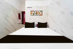 Postel nebo postele na pokoji v ubytování Super Hotel O Coimbatore Hopes College