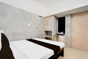 Postel nebo postele na pokoji v ubytování Super Hotel O Coimbatore Hopes College