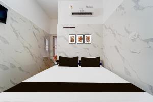 Postel nebo postele na pokoji v ubytování Super Hotel O Coimbatore Hopes College
