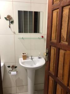a bathroom with a white sink and a mirror at Casa Mundo Buzios in Buzios
