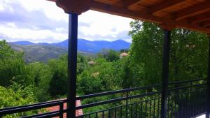 a view of the mountains from the porch of a house at Dafni Apartments in Kastri