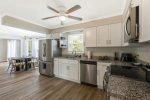 a kitchen with stainless steel appliances and a table at Private Neighborhood Getaway - Big Backyard & Game Room in Cedar Grove