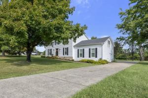 a white house with a tree and a driveway at Private Neighborhood Getaway - Big Backyard & Game Room in Cedar Grove +30 photos