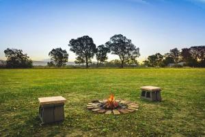 a fire pit in the middle of a field at Pyrenees Views by Tiny Away in Avoca