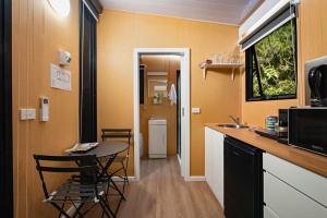a kitchen with a counter and a table with chairs at Pyrenees Views by Tiny Away in Avoca