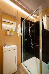 a bathroom with a shower and a sink and a glass shower stall at Pyrenees Views by Tiny Away in Avoca