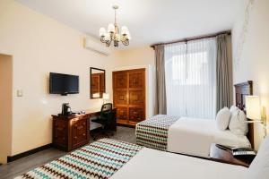 a hotel room with two beds and a television at Wyndham Costa del Sol Cusco in Cusco
