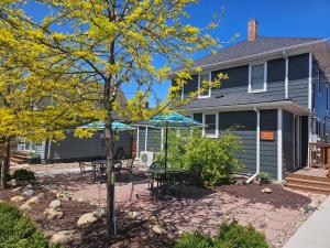 a house with a patio with tables and chairs at Downtown 1 Bedroom Charmer - Walk, Bike, Enjoy!! in Rapid City