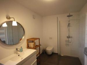 a bathroom with a sink and a mirror and a shower at At the Church Stairs - Holiday Home II in Blankenburg +13 photos