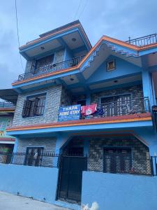a blue building with a sign that reads hotel home stay at Thapa Home Stay in Pokhara
