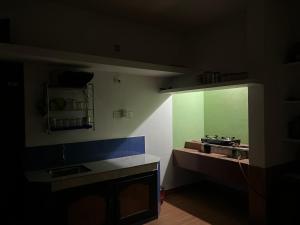 a kitchen with a sink and a mirror on the wall at Oryx Villai in Vythiri