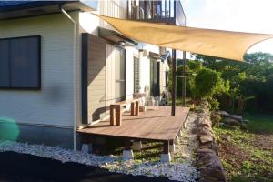 a porch of a house with a bench on it at Retreat House in Yakushima